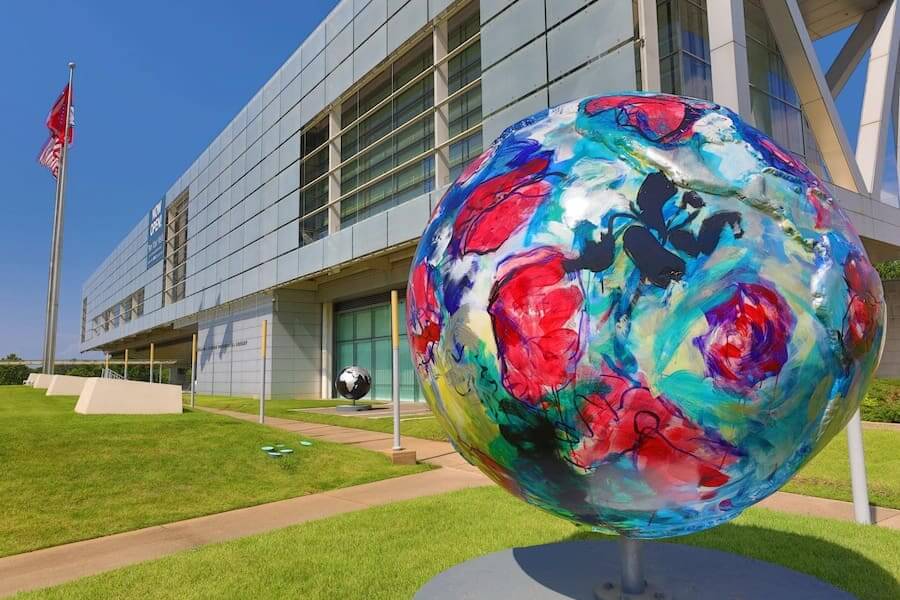 the exterior of the clinton presidential center with a colorful art installation outside