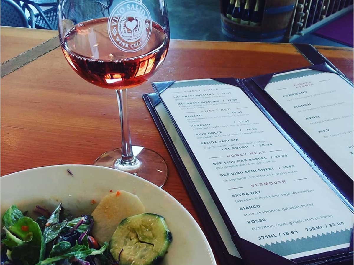 a salad and glass of wine at vinos salida wine bar in colorado