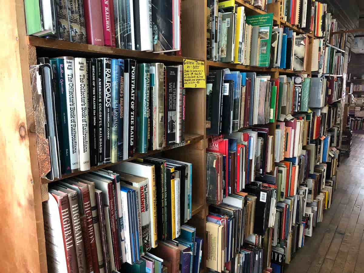 a bookshelf full of used books at john king bookstore
