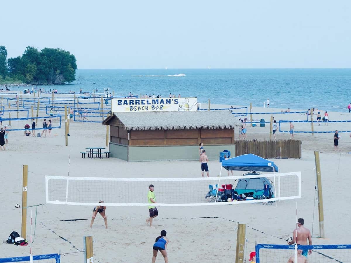 a row of beach volleyball courts along bradford beach