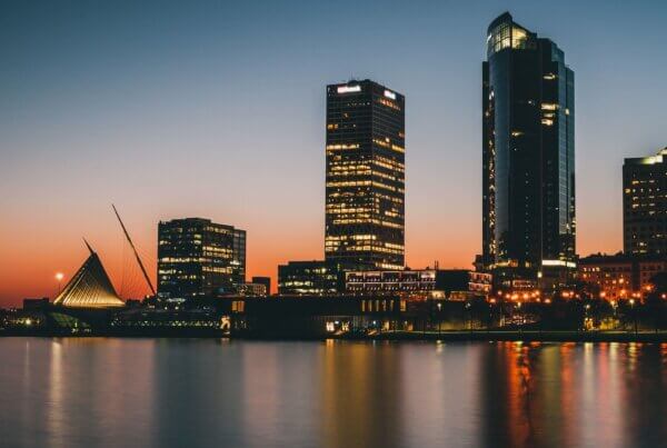 a view from lake michigan of the milwaukee skyline at dusk