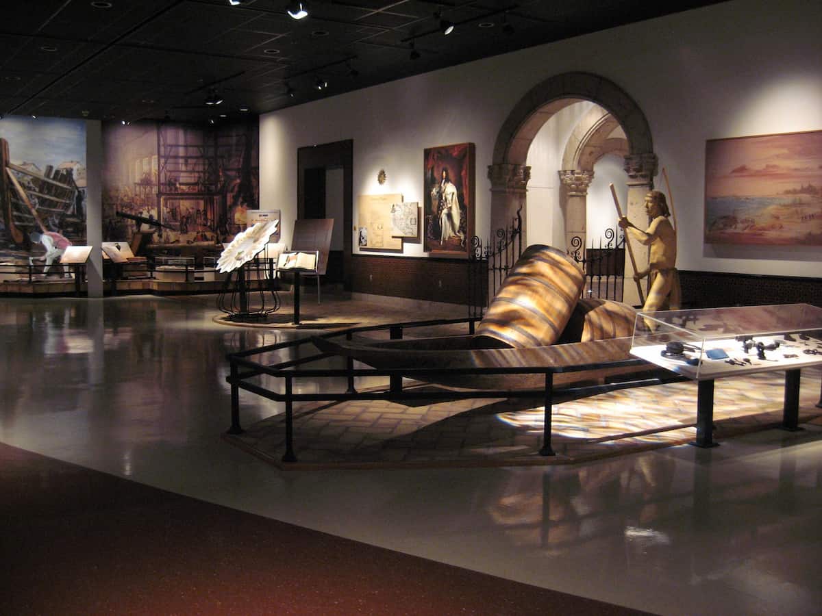 a dimly lit exhibit gallery at the corpus christi museum of science and history