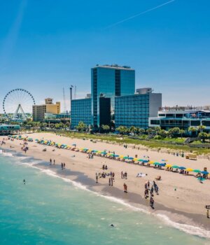 an aerial view of myrtle beach south carolina with hotels and a ferris wheel in the background