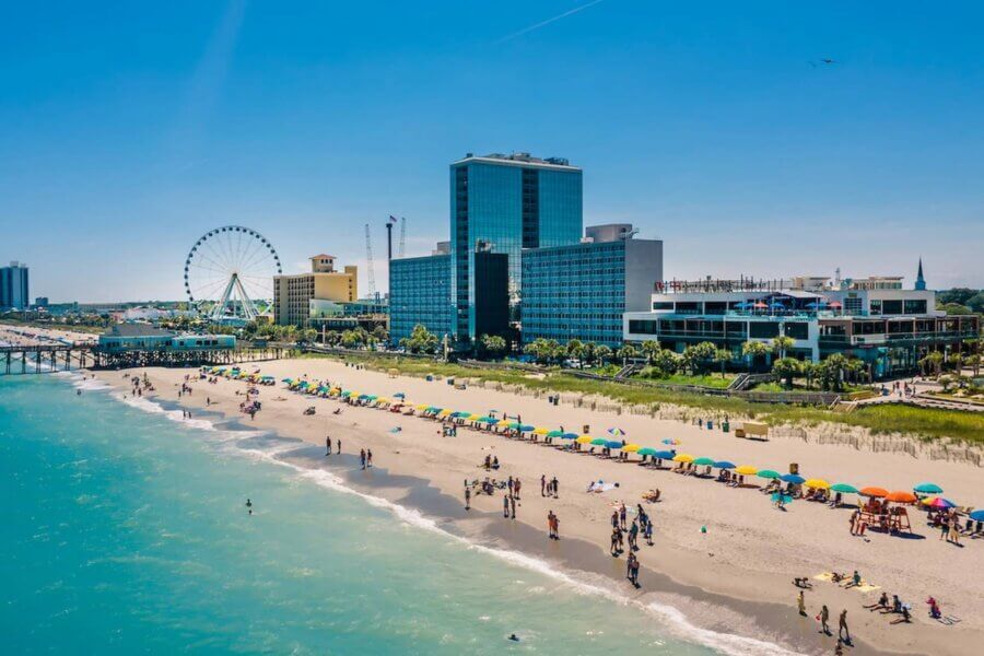 an aerial view of myrtle beach south carolina with hotels and a ferris wheel in the background