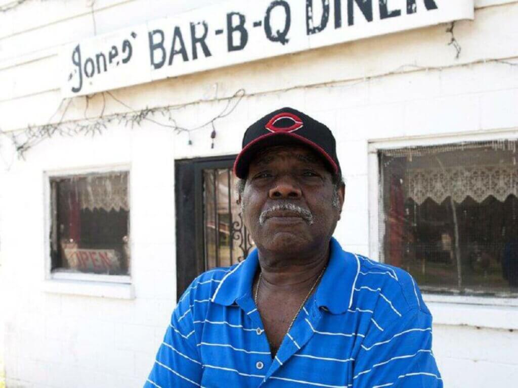 Owner standing in front of Jones' Bar-B-Q Diner