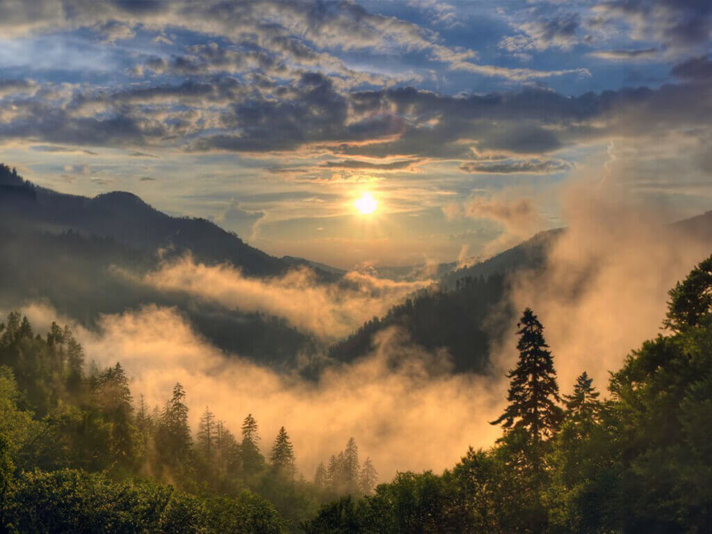 View of a sunrise over the misty mountains of Great Smoky Mountains National Park