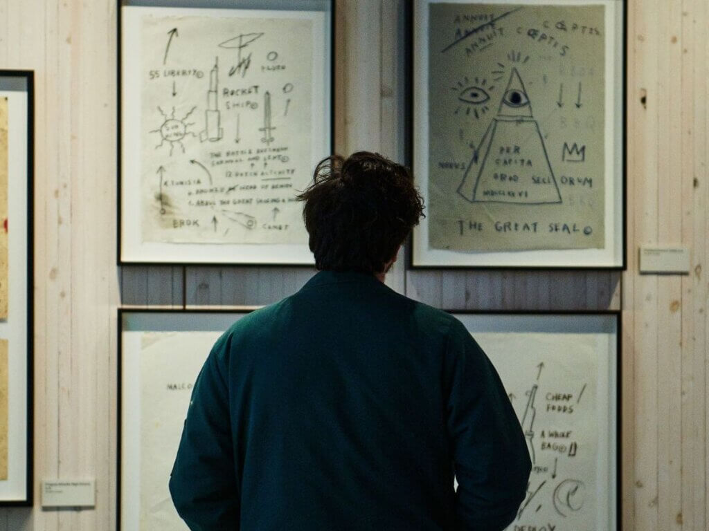 Person admiring Basquiat artwork