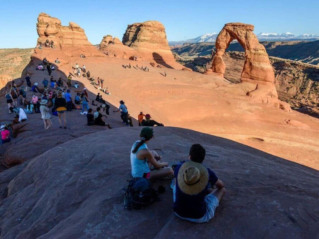 hikers enjoying the scenery at arches national park near moab utah