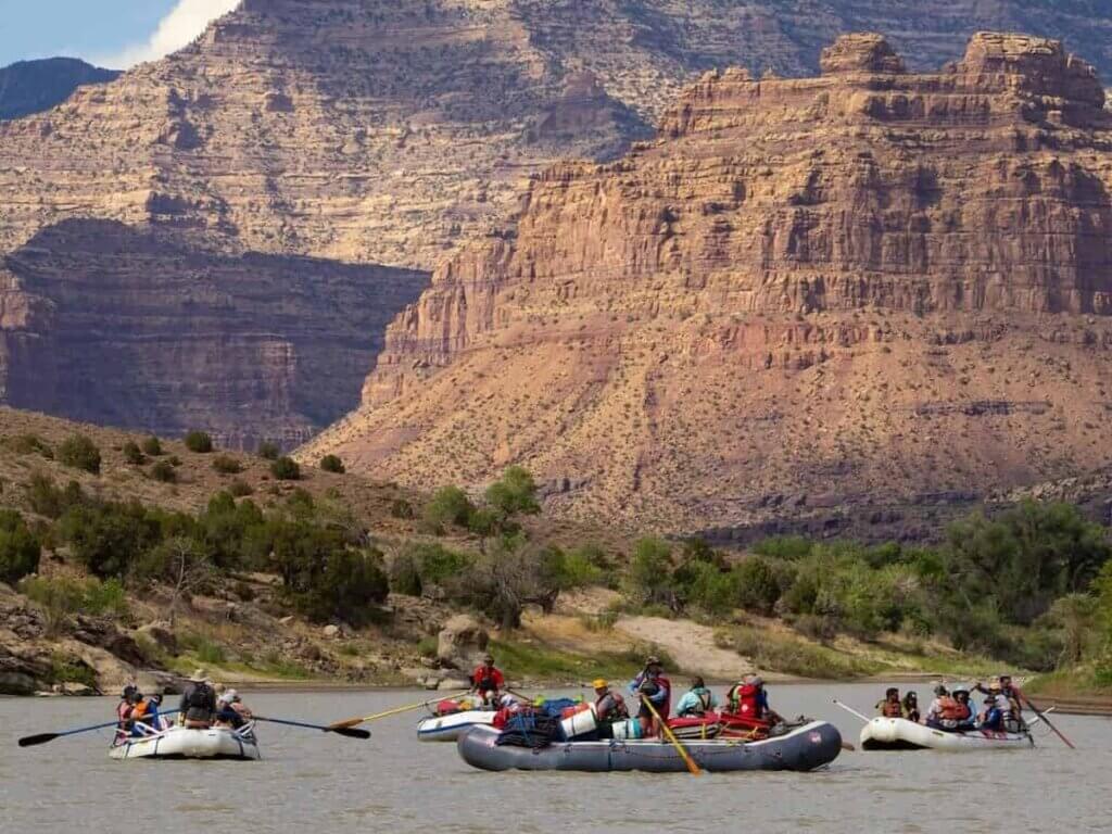 a group of people whitewater rafting along the colorado river