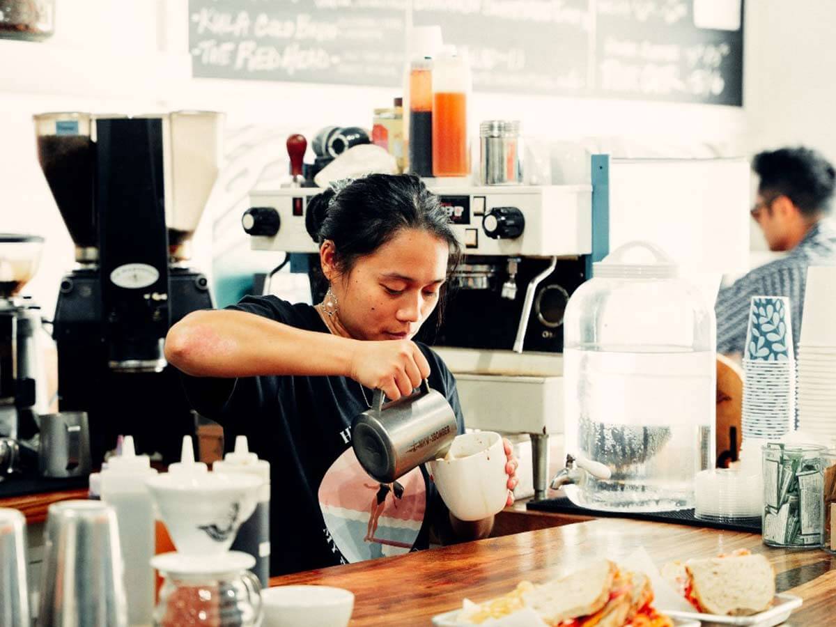 a worker pours Ali'i Coffee Co. in Hawaii
