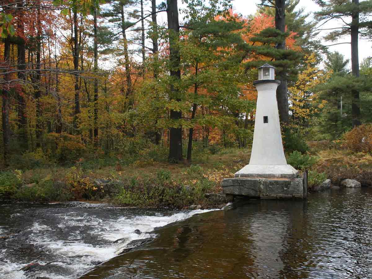 a small rapid in the fall forest of Merrimack Valley new hampshire