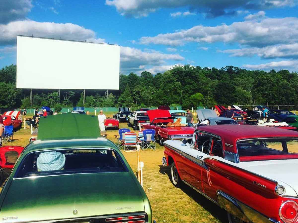 cars in front of the movie screen at delsea drive-in