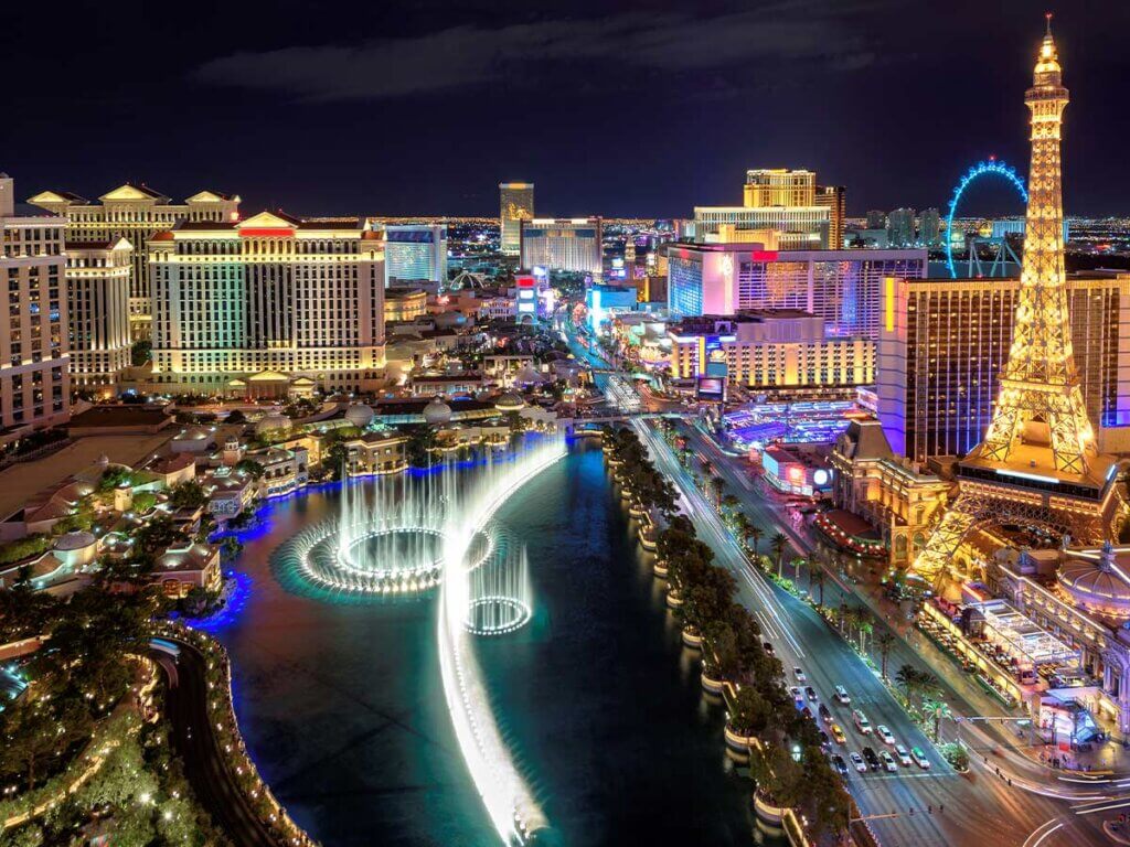Aerial view of dancing fountains and Eiffel Tower at night in Las Vegas