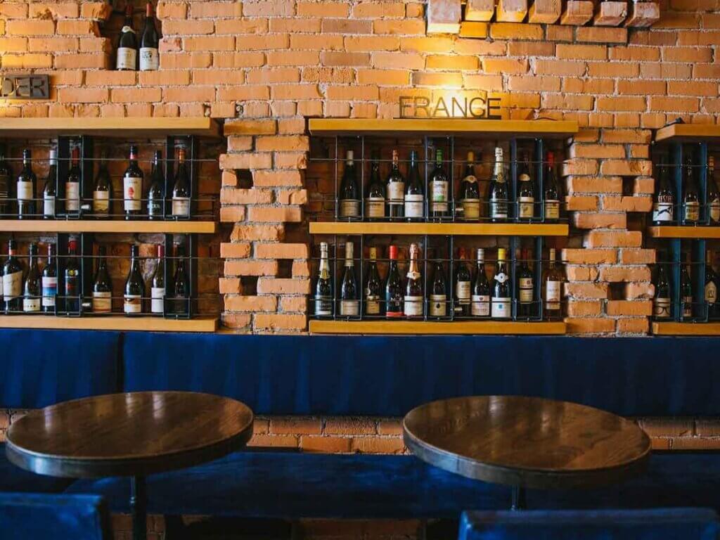 View of barstools and bar at PLONK Wine Bar