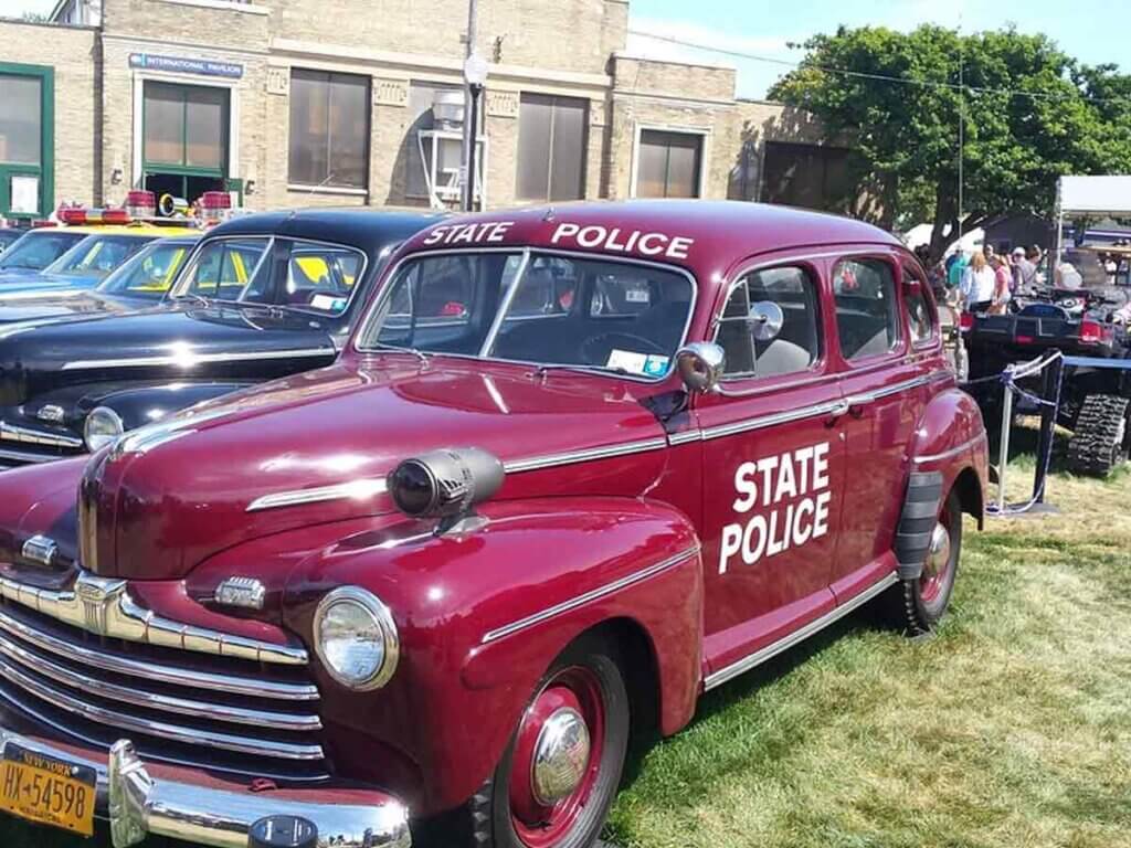 Old-timey state police vehicle at The Great New York State Fair in Syracuse