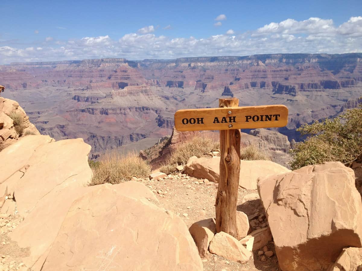 a sign denoting an observation point at the edge of the grand canyon
