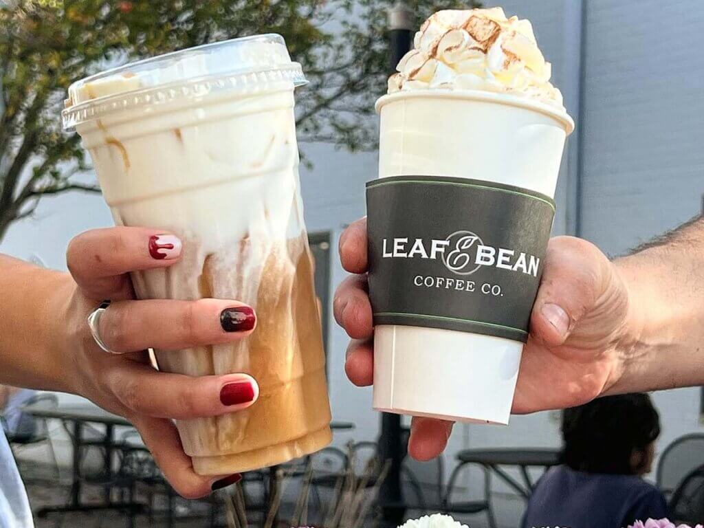 Two people holding their coffee selections from Leaf & Bean Coffee Co. - Chili, NY