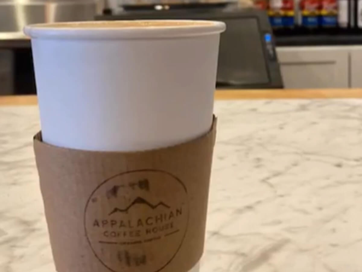 Cup of coffee from Appalachian Coffee House with customized sleeve