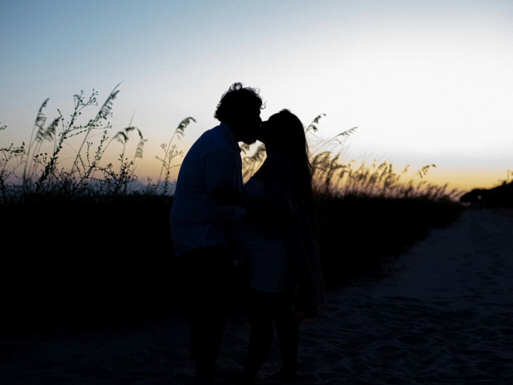 a couple kiss in the long grasses of pascagoula ms